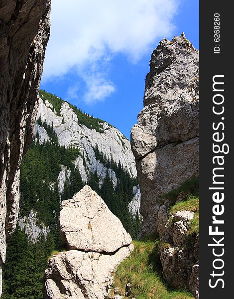 View from a cliff to the mountain ridge in the Romanian Carpathians. View from a cliff to the mountain ridge in the Romanian Carpathians.