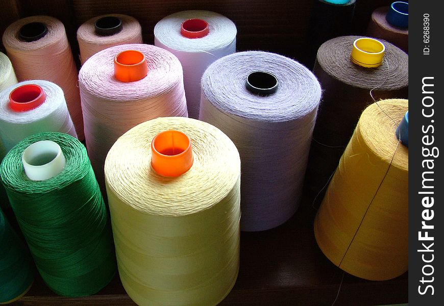 Leers of fine, coloured, threads in a tailor\'s workshop. Leers of fine, coloured, threads in a tailor\'s workshop