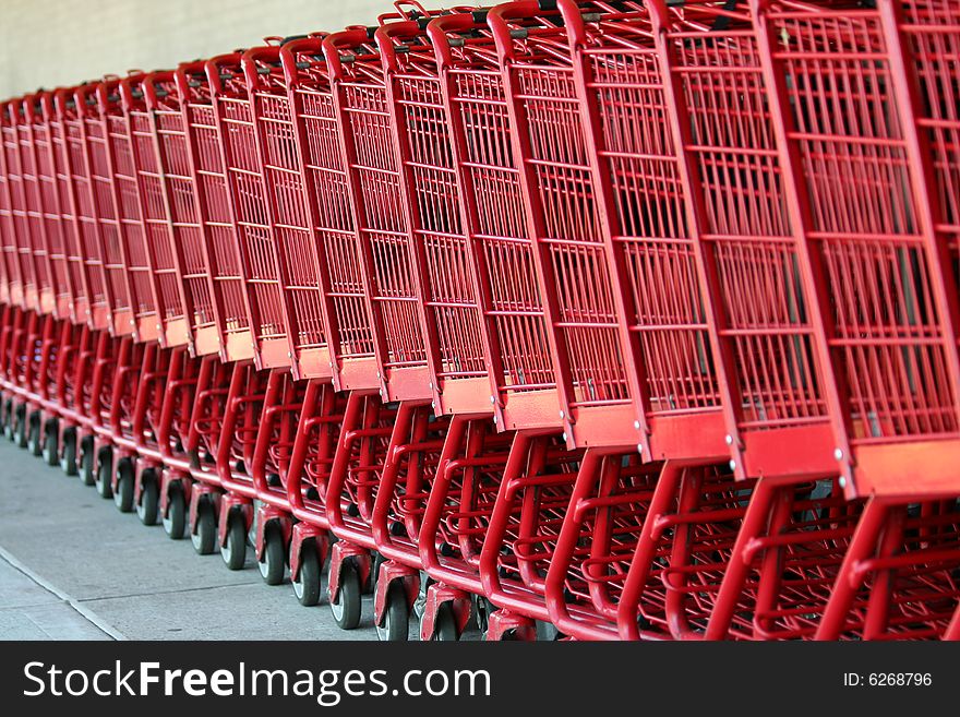 Row of red metal shopping carts