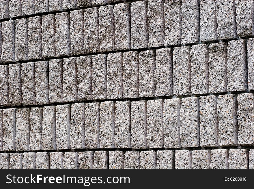 A block wall of cut stone blocks. A block wall of cut stone blocks