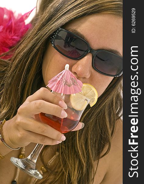 Girl sitting and drinking cocktail with lemon