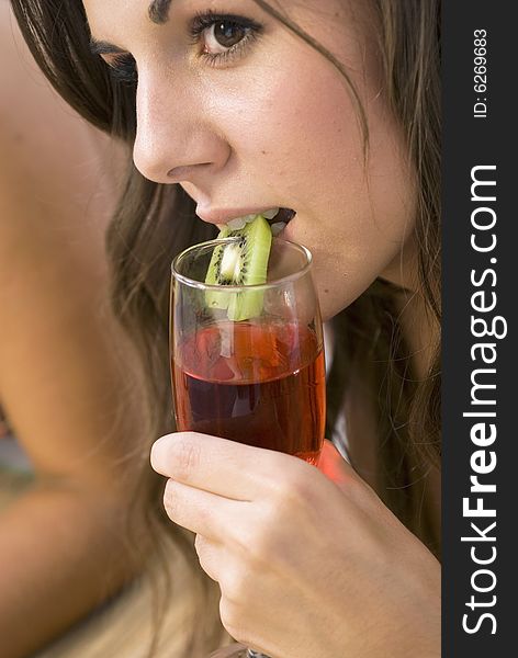 Girl sitting and drinking cocktail with kiwi. Girl sitting and drinking cocktail with kiwi