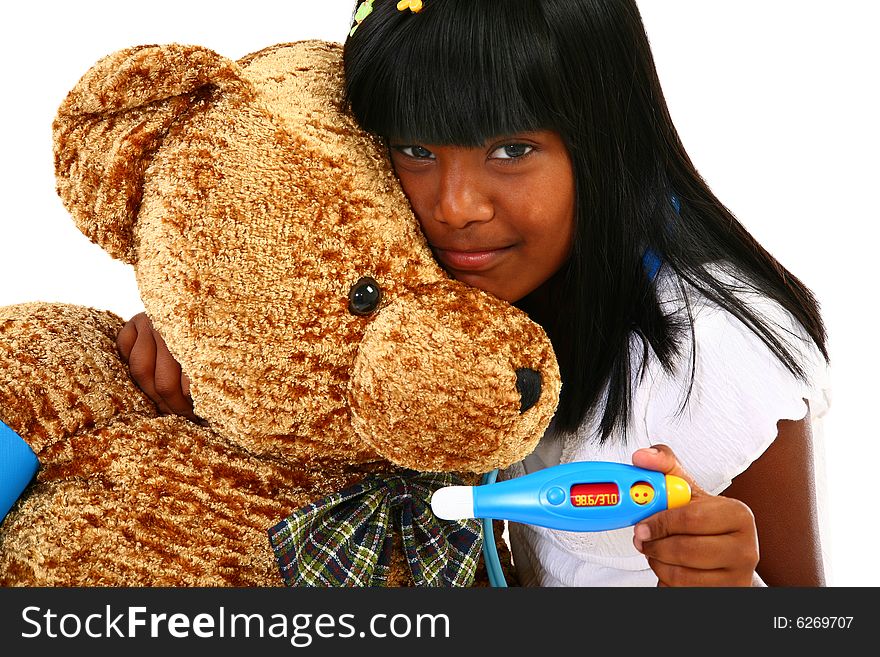 Beautiful Indian girl playing nurse to giant teddy bear. Beautiful Indian girl playing nurse to giant teddy bear.