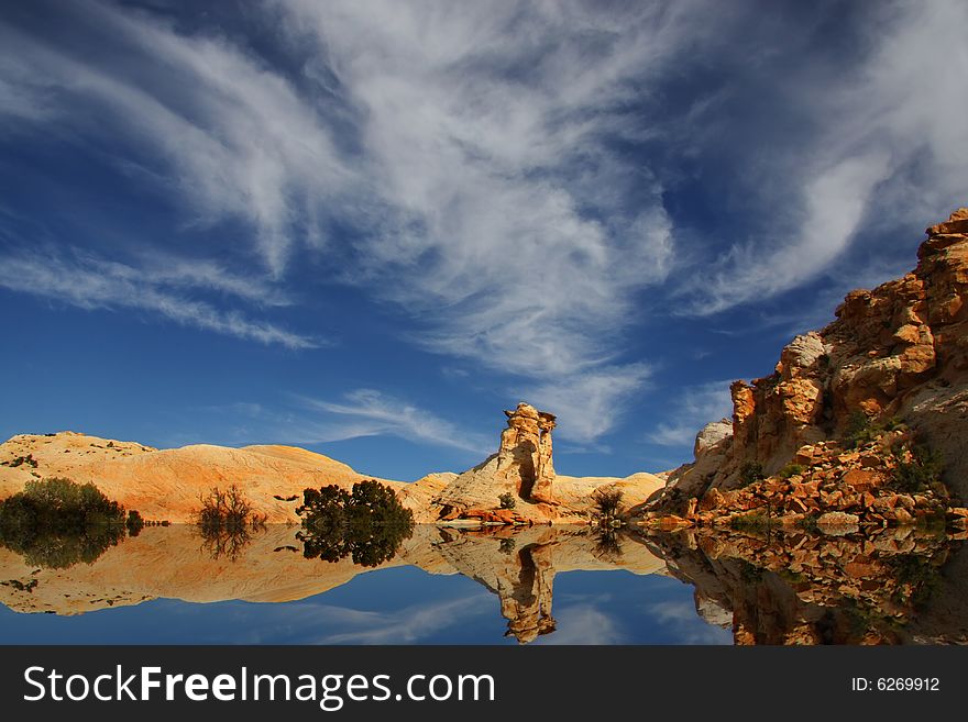 View of the red rock formations in San Rafael Swell with blue skyï¿½s and clouds. View of the red rock formations in San Rafael Swell with blue skyï¿½s and clouds