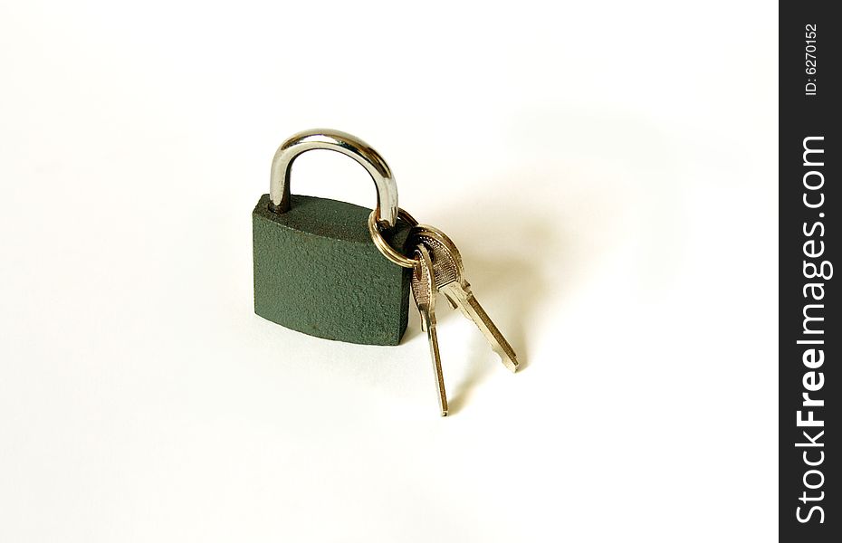 Closed padlock with keys standing on white background