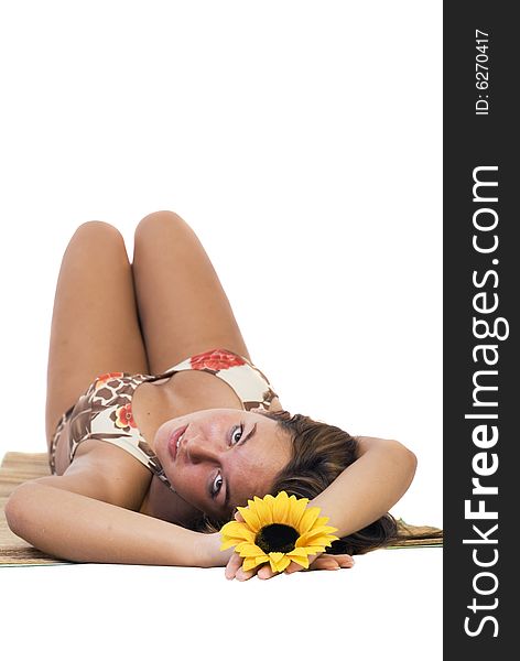 Cute girl on the floor relaxing while holding a sunflower. Cute girl on the floor relaxing while holding a sunflower