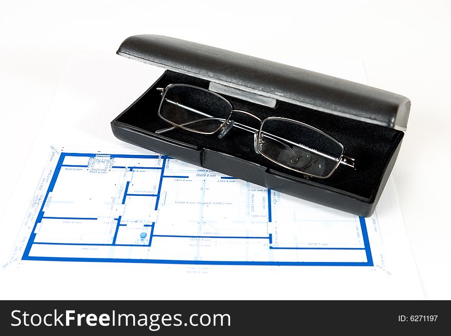 Blueprint for a house and eyeglasses