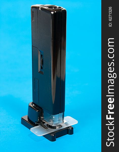 Pocket microscope on blue background