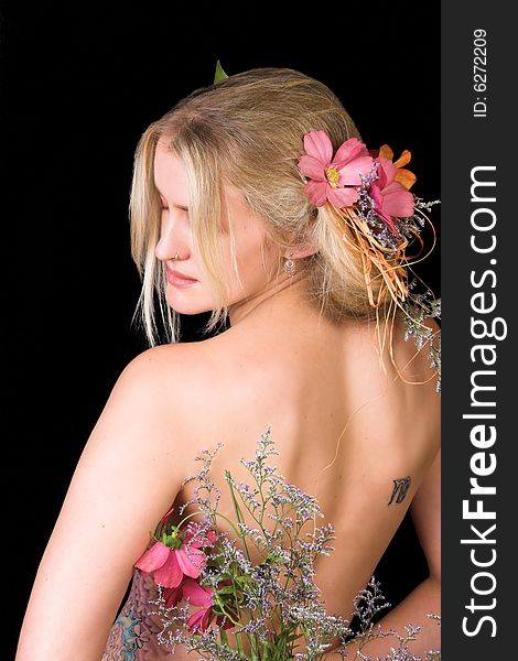 Beautiful young blond model with flowers in her hair. Beautiful young blond model with flowers in her hair