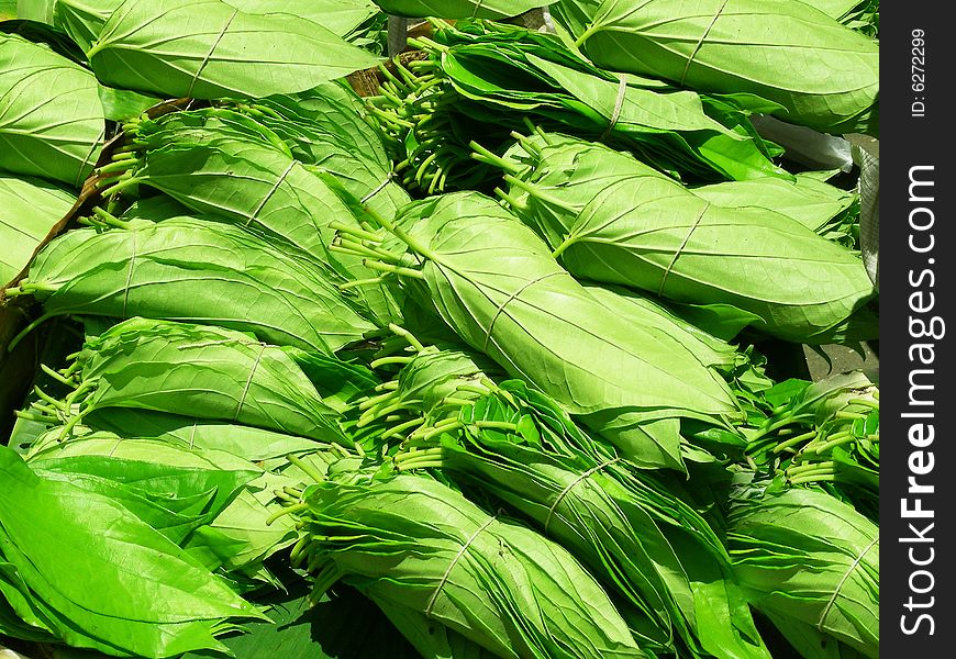 Lots of bunches of tied beetlenut leaves on sale/ display