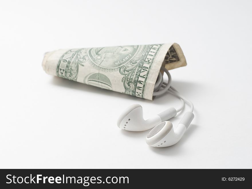 Ear buds in a rolled dollar note. Ear buds in a rolled dollar note.