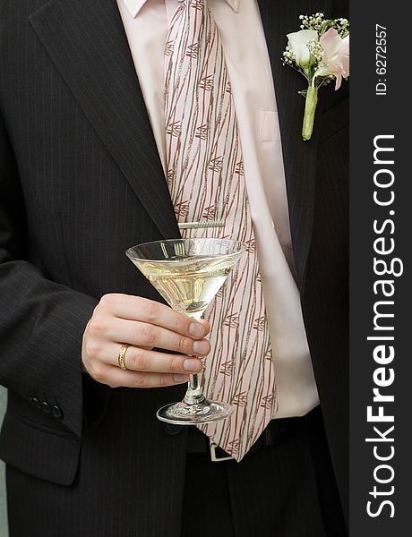 Wine glass in a hand of bridegroom