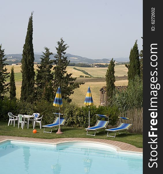Summer countryside in Tuscany with cypress and pool. Summer countryside in Tuscany with cypress and pool