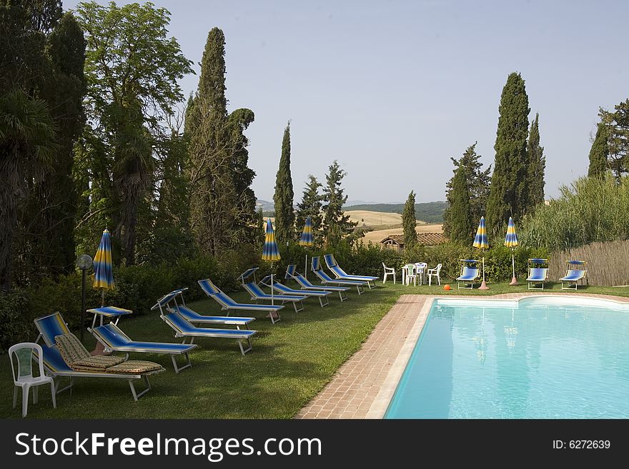 Summer countryside in Tuscany with cypress and pool. Summer countryside in Tuscany with cypress and pool