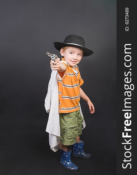 Young boy playing dressed up in hat and cape. Young boy playing dressed up in hat and cape