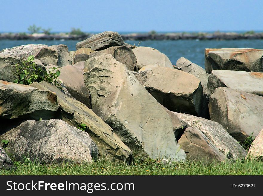 Large pile of rocks to keep the waves from eroding the lake shore. Large pile of rocks to keep the waves from eroding the lake shore