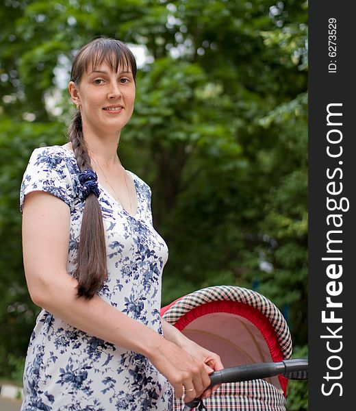 Young woman with red baby carriage. Young woman with red baby carriage