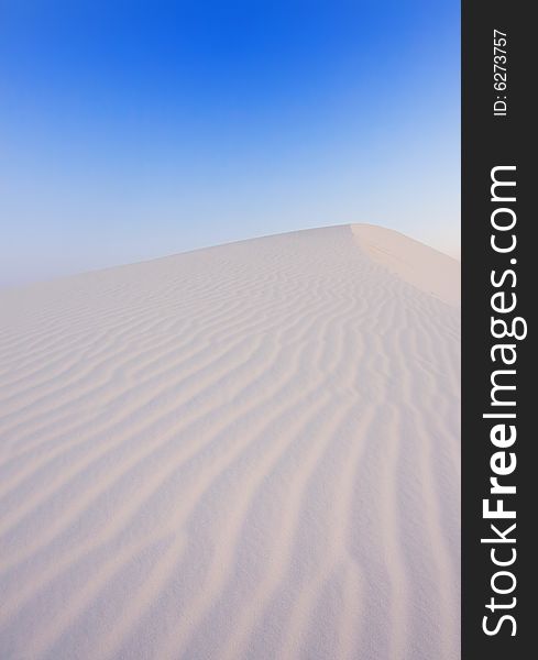 An image of soft sand dunes at dawn. An image of soft sand dunes at dawn