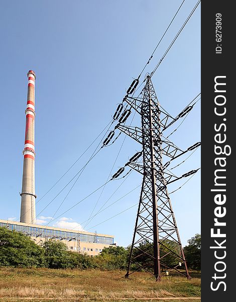Transmission tower before heating plant with high chimney