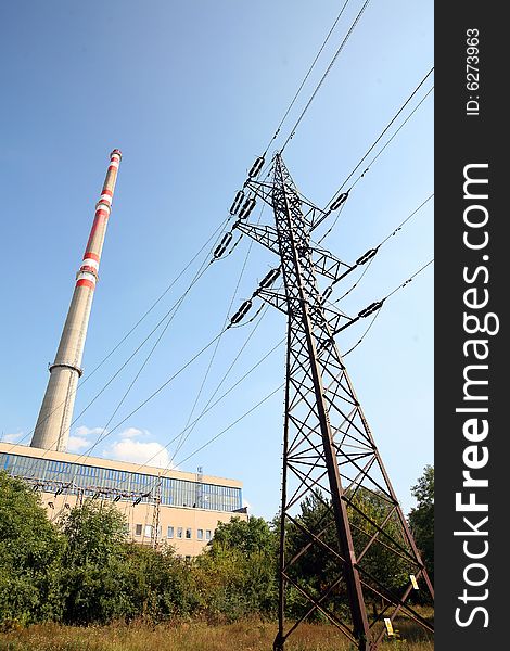 Transmission tower before heating plant with high chimney
