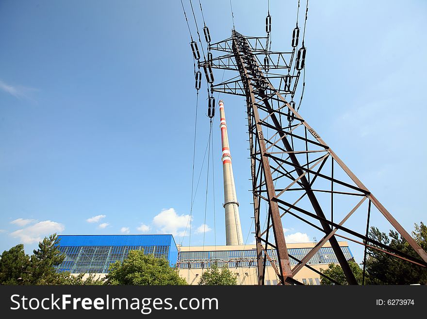 Transmission tower before heating plant with high chimney