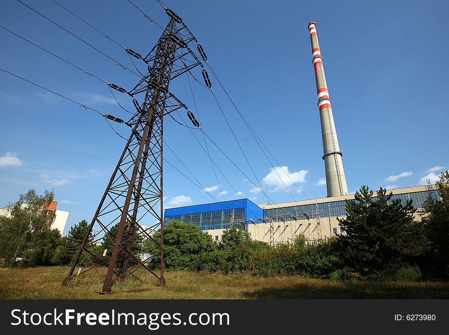 Transmission tower before heating plant with high chimney