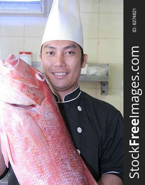 Chef and red snapper fish smiling