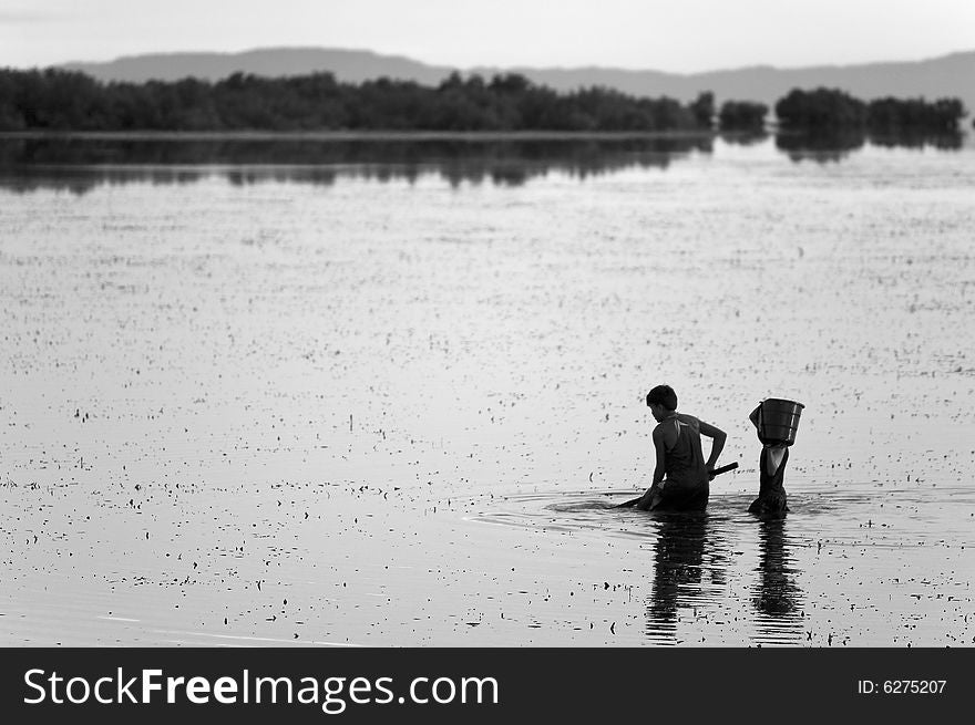 Young kids fishing off the calm sea waters in Day-as, Cordova, Cebu, Philippines. Young kids fishing off the calm sea waters in Day-as, Cordova, Cebu, Philippines.