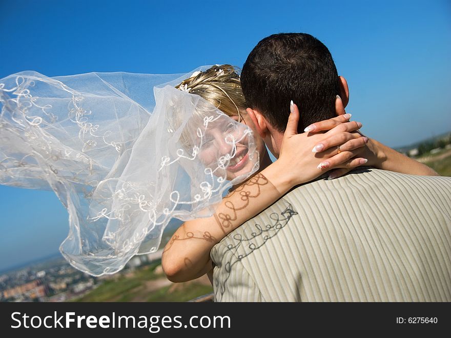 Groom and bride with a flying veil outdoor. Groom and bride with a flying veil outdoor