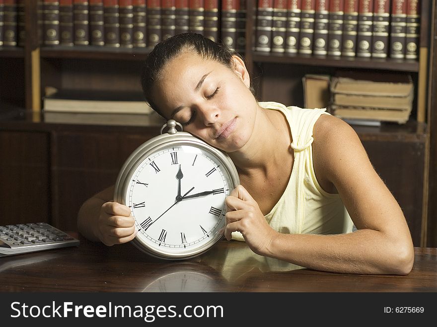 Girl in office sleeping on a clock - Horizontally framed photo. Girl in office sleeping on a clock - Horizontally framed photo.