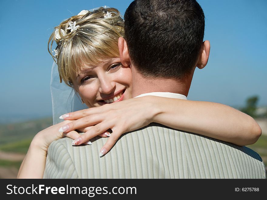 Happy bride and groom embracing outdoor. Happy bride and groom embracing outdoor