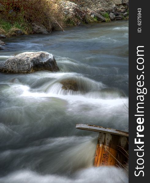 Provo River flowing spedily along with a spool in the water. Provo River flowing spedily along with a spool in the water.