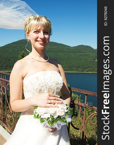 Happy young bride with a bouquet outdoor. Happy young bride with a bouquet outdoor