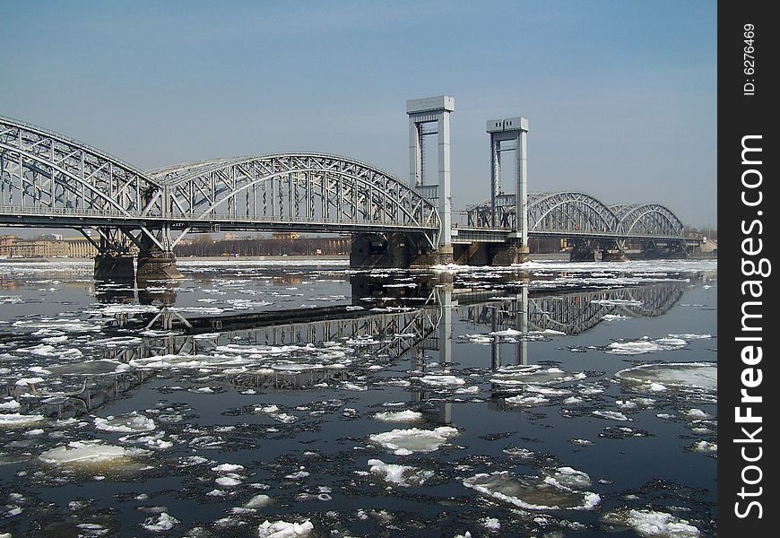 Bridge across the river Neva and his reflection during drifting of ice , Sankt is Petersburg, Russia