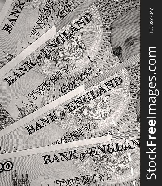 Sepia toned close-up of twenty pound notes