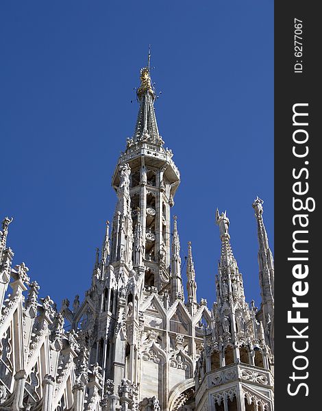 The highest spire of the cathedral of milan with madoninna