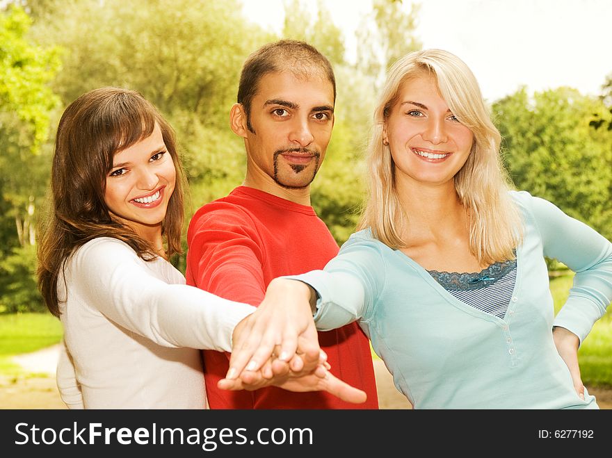 Group of young people put hands on top of each other