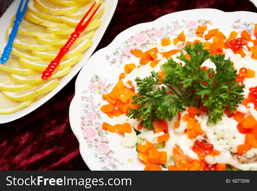 Salad and lemon on the table. Salad and lemon on the table