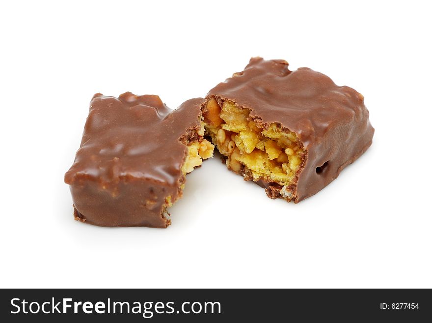 Chocolate with peanut and seasame sliced into half on white background.