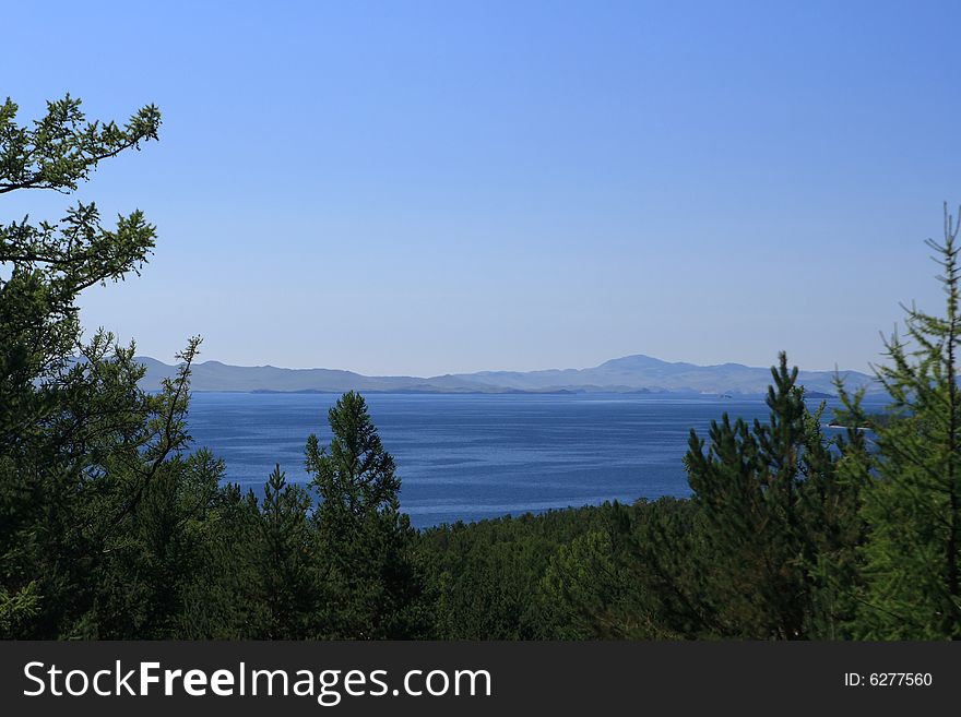 View on clear lake through forest. View on clear lake through forest