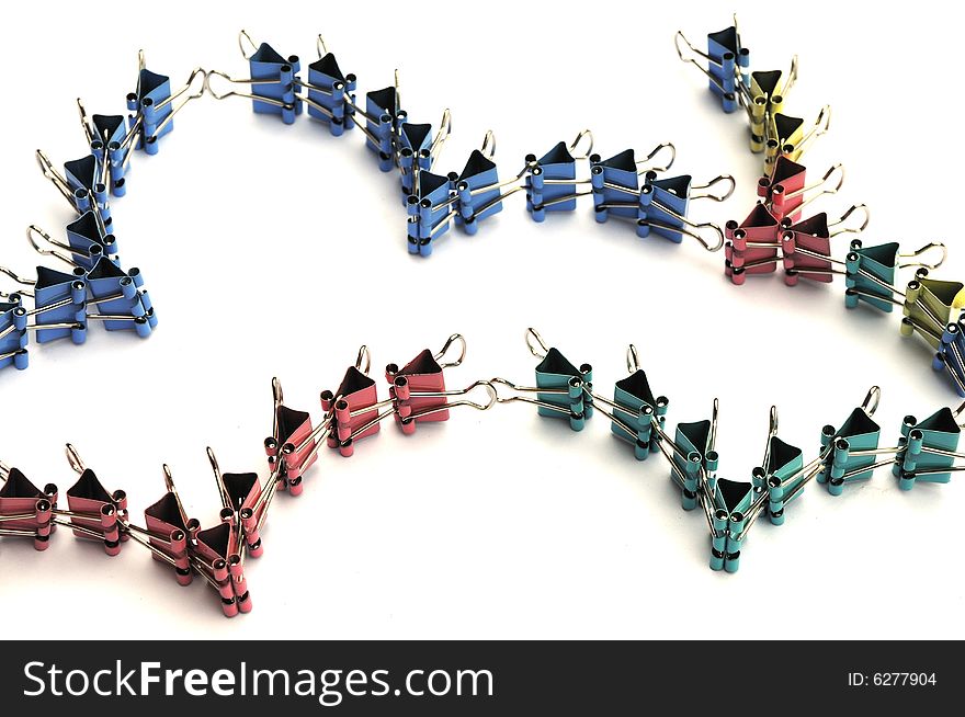 The colorful small iron clamps linked as a flying bird wings. The colorful small iron clamps linked as a flying bird wings.