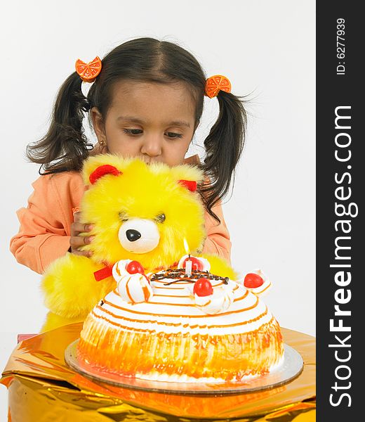 Asian girl celebrating birthday with teddy bear