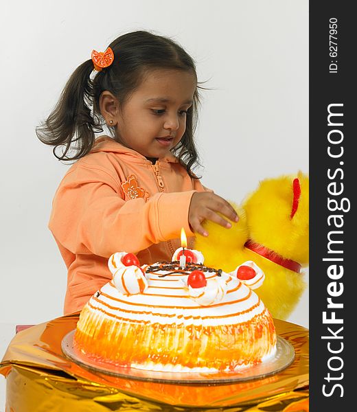 Asian girl celebrating birthday with teddy bear