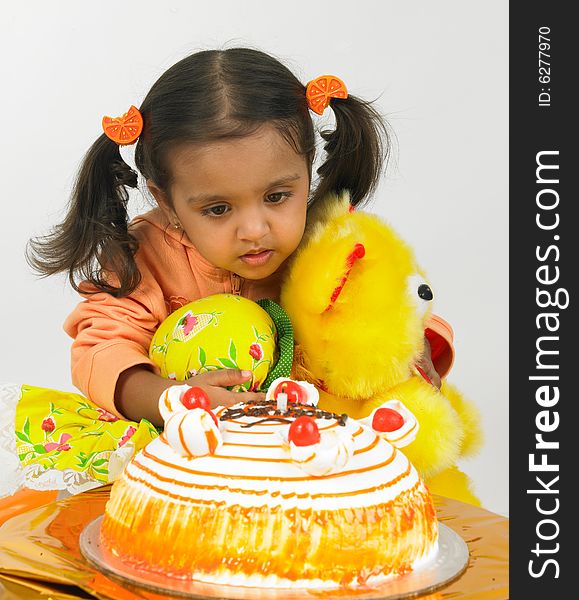 Asian girl celebrating birthday with teddy bear