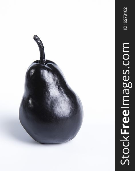 Black pear on a white background close up