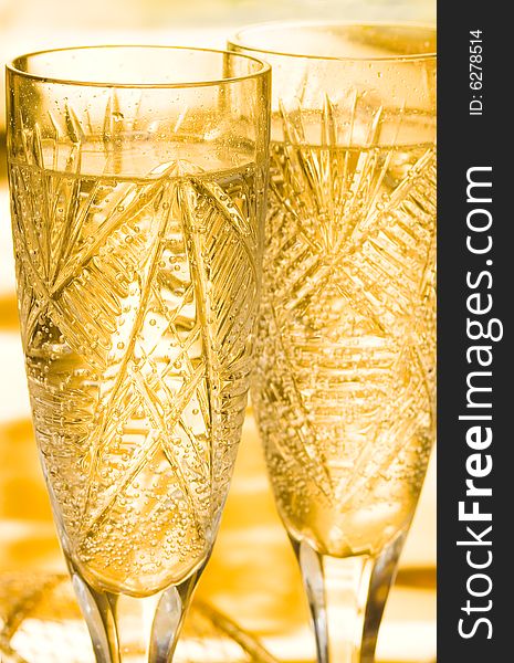 Champagne in glass on yellow background