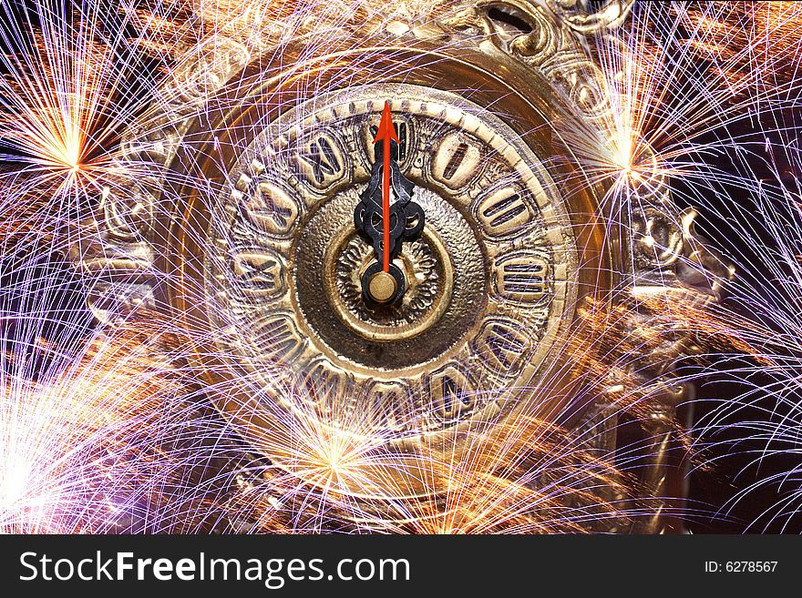 Showing on background of fireworks twelfth hour clock