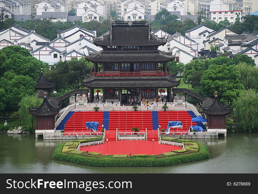 A Chinese ancient building in a park beside a lake. A Chinese ancient building in a park beside a lake.