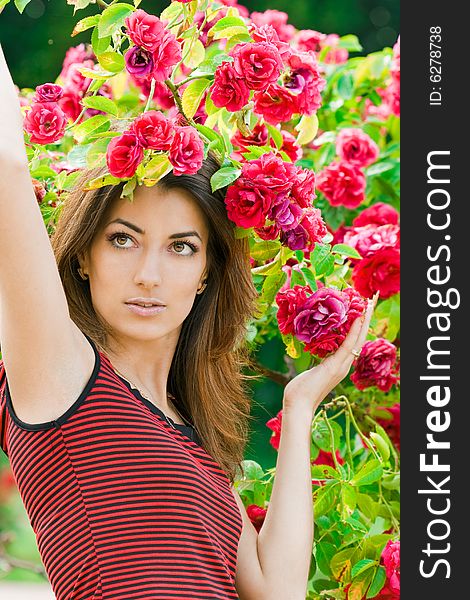 Beautiful woman in garden with roses. Beautiful woman in garden with roses