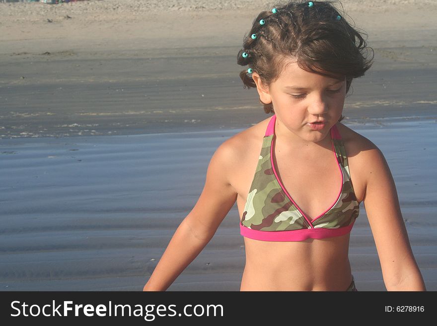 Young girl walking at the beach. Young girl walking at the beach.